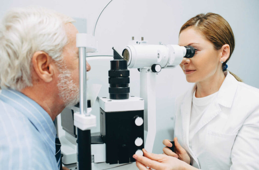 A female optometrist assessing a male patient's eyes during a diabetic eye exam.