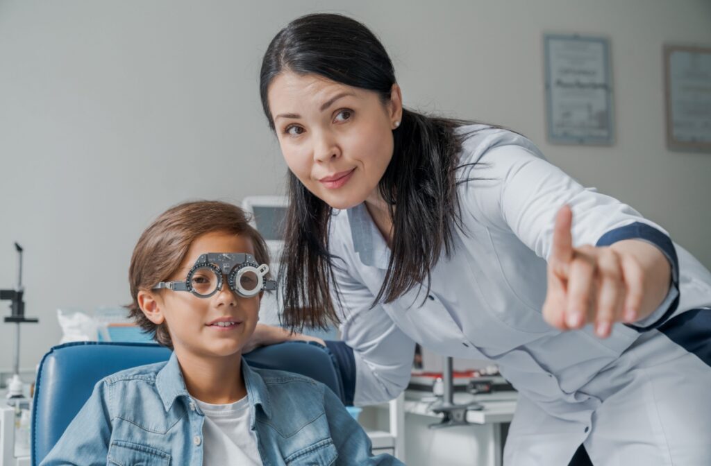 Optometrist guiding a child through an eye exam with specialized glasses