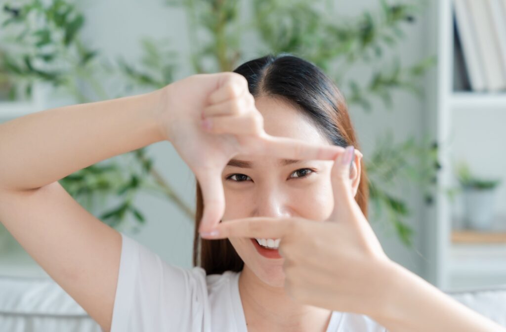 A person framing their eyes with their pointer fingers and thumbs